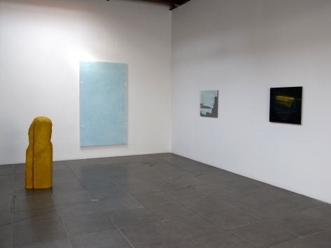 Installation of the art exhibition "Heat Waves" with 3 paintings on white walls and a yellow aqua resin sculpture