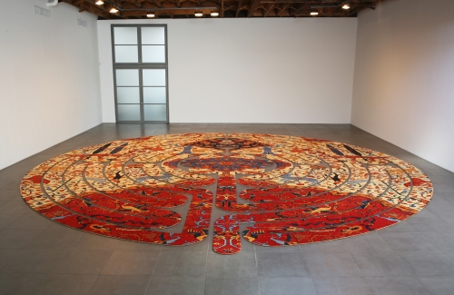 Artwork made by Su-Mei Tse_Proposition de détour, 2006, wool carpet_Tse got a rugmaker to reproduce an enlarged portion of a Persian carpet in the Paradise Garden style -- animals lounge among luxuriant blooms. Then she had it cut out to duplicate each twist and turn of the famous labyrinth at Chartres, inlaid into the cathedral's floor around the year 1200_29 feet 6 inches diameter (9 meters diameter)